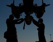 Staff Sgt. Stefano Cothran and Senior Airman Nicholas Gillette, 2nd Aircraft Maintenance Squadron weapons load team, secures a GBU-38 to a pylon during the 2014 Global Strike Challenge on Barksdale Air Force Base, La., Aug. 27. Bomb Wings competed in various challenges to include preflight inspections, munition builds and loads, with the winning bomb wing receiving the Fairchild Trophy in November, and bragging rights for a year. (U.S. Air Force photo/Senior Airman Benjamin Gonsier)