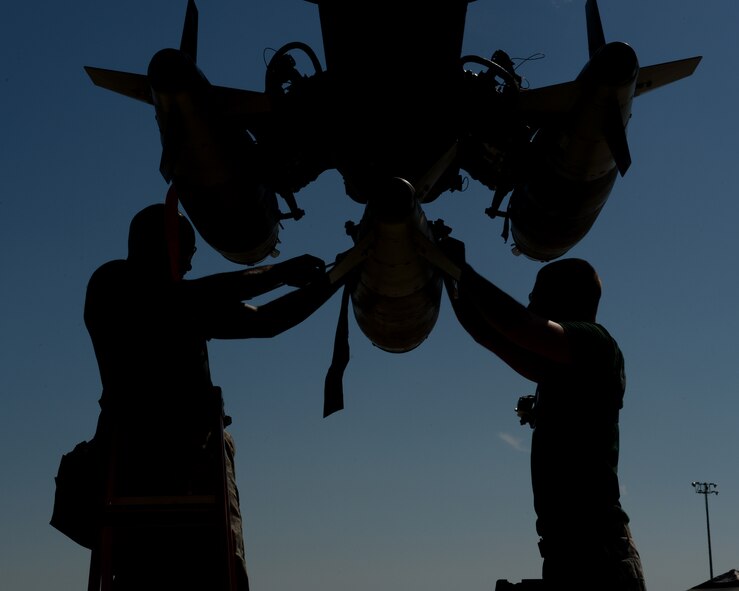 Staff Sgt. Stefano Cothran and Senior Airman Nicholas Gillette, 2nd Aircraft Maintenance Squadron weapons load team, secures a GBU-38 to a pylon during the 2014 Global Strike Challenge on Barksdale Air Force Base, La., Aug. 27. Bomb Wings competed in various challenges to include preflight inspections, munition builds and loads, with the winning bomb wing receiving the Fairchild Trophy in November, and bragging rights for a year. (U.S. Air Force photo/Senior Airman Benjamin Gonsier)