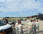 Spectators watch Airmen from the 2nd Aircraft Maintenance Squadron load munitions onto a B-52H Stratofortress during the 2014 Global Strike Challenge on Barksdale Air Force Base, La., Aug. 27. The purpose of the challenge is to recognize outstanding Air Force Global Strike Command personnel and teams and improve combat capabilities through competition and community crosstalk. (U.S. Air Force photo/Senior Airman Benjamin Gonsier)