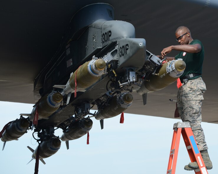 Staff Sgt. Stefano Cothran, 2nd Aircraft Maintenance Squadron weapons load team, secures a GBU-38 to a pylon during the 2014 Global Strike Challenge on Barksdale Air Force Base, La., Aug. 27. Up to eight GBU-38 Joint Direct Attack Munitions can now be carried inside the bomb bay of the B-52H Stratofortress, thanks to the 1760 Internal Weapons Bay Upgrade. The upgrade also increases the number of JDAMs that can be externally carried to 16, for a total payload increase of 100 percent. (U.S. Air Force photo/Senior Airman Benjamin Gonsier)