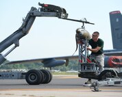 Senior Airman Nicholas Gillette, 2nd Aircraft Maintenance Squadron weapons load team, secures a GBU-38 to a jammer during the 2014 Global Strike Challenge on Barksdale Air Force Base, La., Aug. 27. Crew chiefs were evaluated on how quickly they loaded munitions on a B-52H Stratofotress and how many discrepancies were found. (U.S. Air Force photo/Senior Airman Benjamin Gonsier)