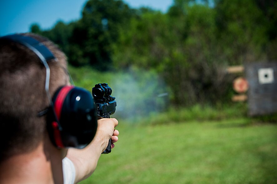 U.S. Air Force Staff Sgt. Jeremiah Jackson, 23d Equipment Maintenance Squadron aircraft metals technology craftsman, fires a round from a .45-caliber pistol in Valdosta, Ga., Aug. 15, 2014. Of the five shooting classifications, Jackson is currently in the master classification, which is only one below the highest attainable classification, high master. (U.S. Air Force photo by Staff Sgt. Jamal D. Sutter/Released)  