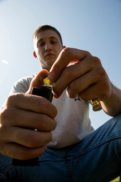 U.S. Air Force Staff Sgt. Jeremiah Jackson, 23d Equipment Maintenance Squadron aircraft metals technology craftsman, loads rounds to a magazine during pistol shooting practice in Valdosta, Ga., Aug. 21, 2014. During a practice session, Jackson says he shoots about 300 rounds, covering various shooting drills he’d encounter at competitions. (U.S. Air Force photo by Staff Sgt. Jamal D. Sutter/Released) 