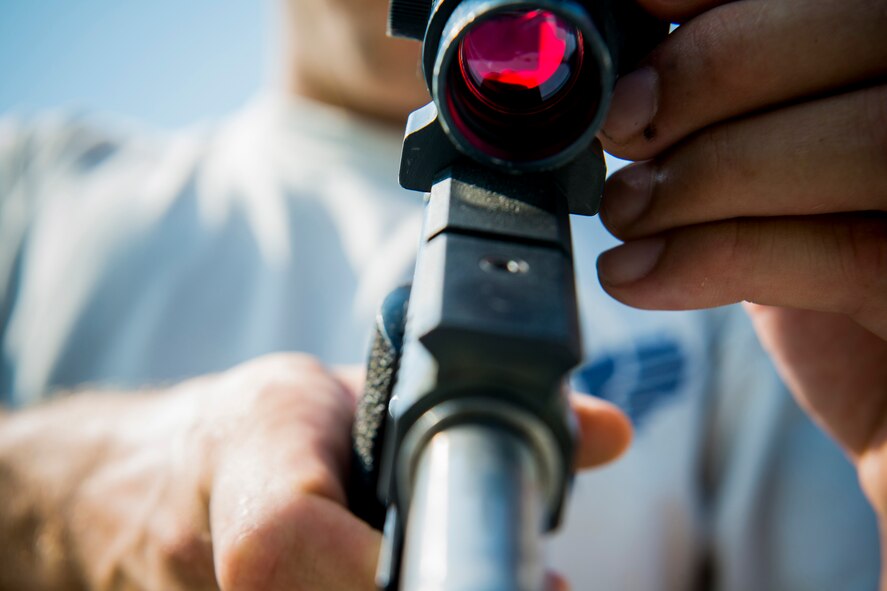 U.S. Air Force Staff Sgt. Jeremiah Jackson, 23d Equipment Maintenance Squadron aircraft metals technology craftsman, adjusts the sight to a .45-caliber pistol in Valdosta, Ga., Aug. 15, 2014. Jackson says zeroing his pistol before an event is important but weather conditions during competition can call for minor adjustments on the fly. (U.S. Air Force photo by Staff Sgt. Jamal D. Sutter/Released) 