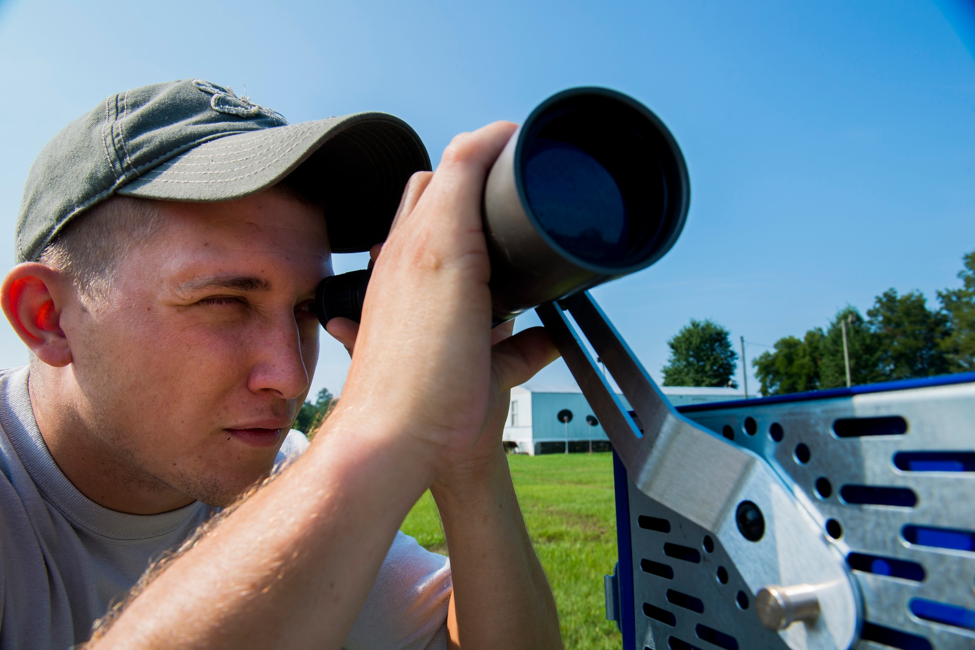 U.S. Air Force Staff Sgt. Jeremiah Jackson, 23d Equipment Maintenance Squadron aircraft metals technology craftsman, looks through a target scope during pistol shooting practice in Valdosta, Ga., Aug. 15, 2014. Jackson began taking pistol shooting seriously while stationed at Lackland Air Force Base, Texas, in 2010, and is currently a member of the Air Force National Pistol Team. (U.S. Air Force photo by Staff Sgt. Jamal D. Sutter/Released) 