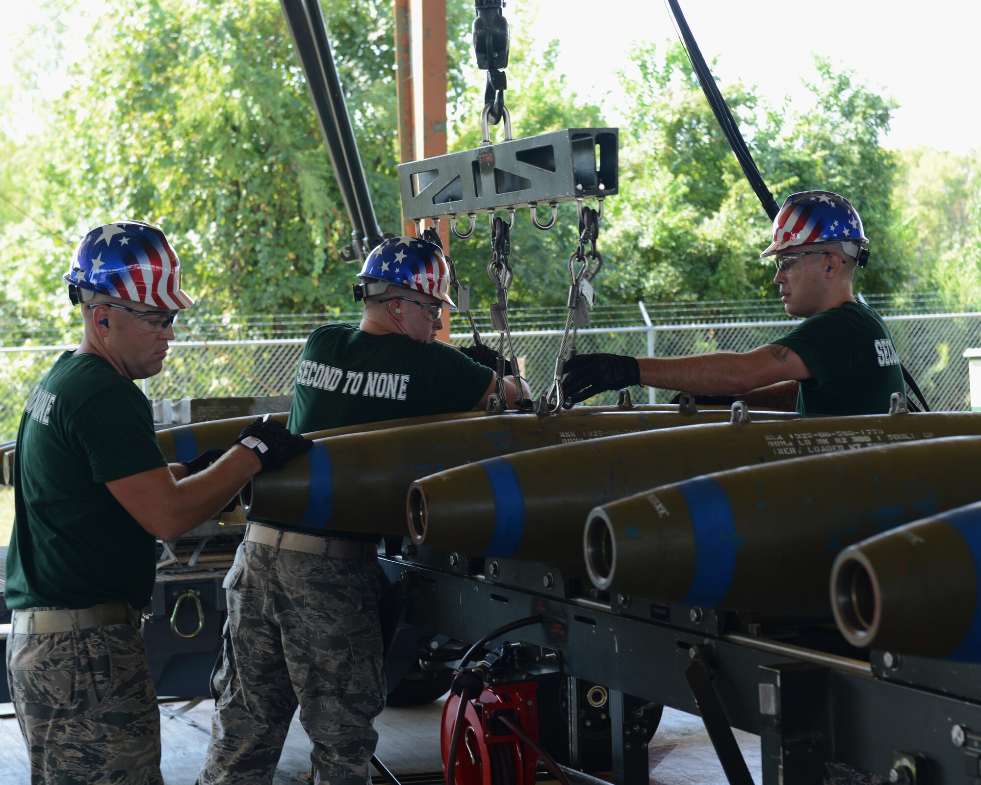 Airmen from the 2nd Munitions Squadron transfer GBU-38 bombs to a bomb trolley during the 2014 Global Strike Challenge on Barksdale Air Force Base, La., Aug. 26. The bomb building team competed in various areas of build-up to include torque requirements, trailer loading procedures, technical order knowledge and safety procedures. (U.S. Air Force photo/Senior Airman Benjamin Gonsier)