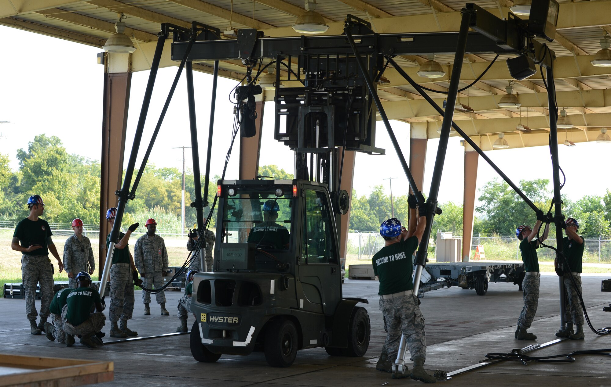 Airmen from the 2nd Munitions Squadron raise a munitions assembly conveyor during the 2014 Global Strike Challenge on Barksdale Air Force Base, La., Aug. 26. The MAC is a piece of equipment used to build bombs. (U.S. Air Force photo/Senior Airman Benjamin Gonsier)