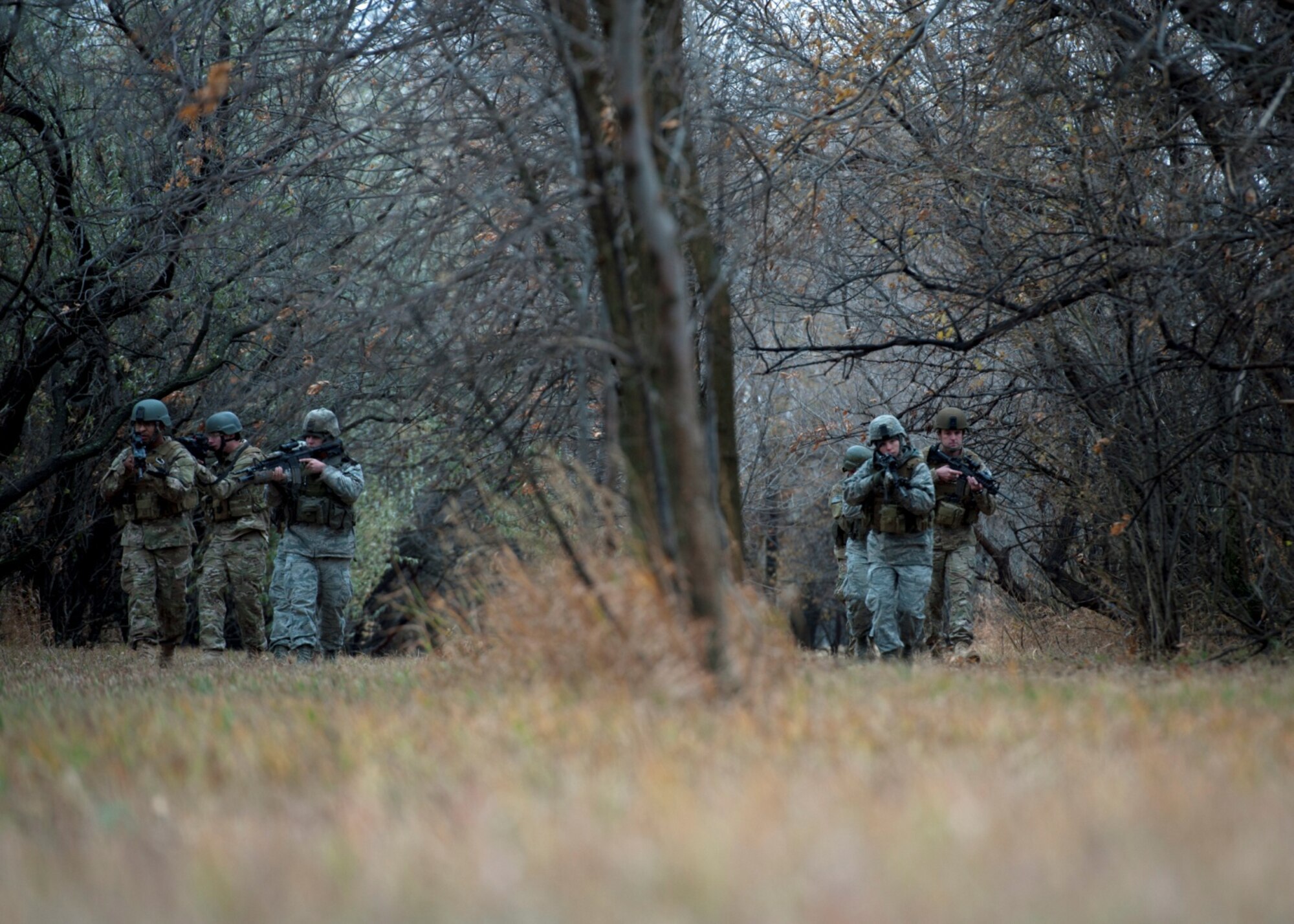 Security Forces Airmen perform a training patrol at Minot Air Force Base, N.D. The Airman on the left is wearing an OCP (MultiCam) uniform, where the Airman on the right is wearing ABUs. (U.S. Air Force Courtesy Photo)