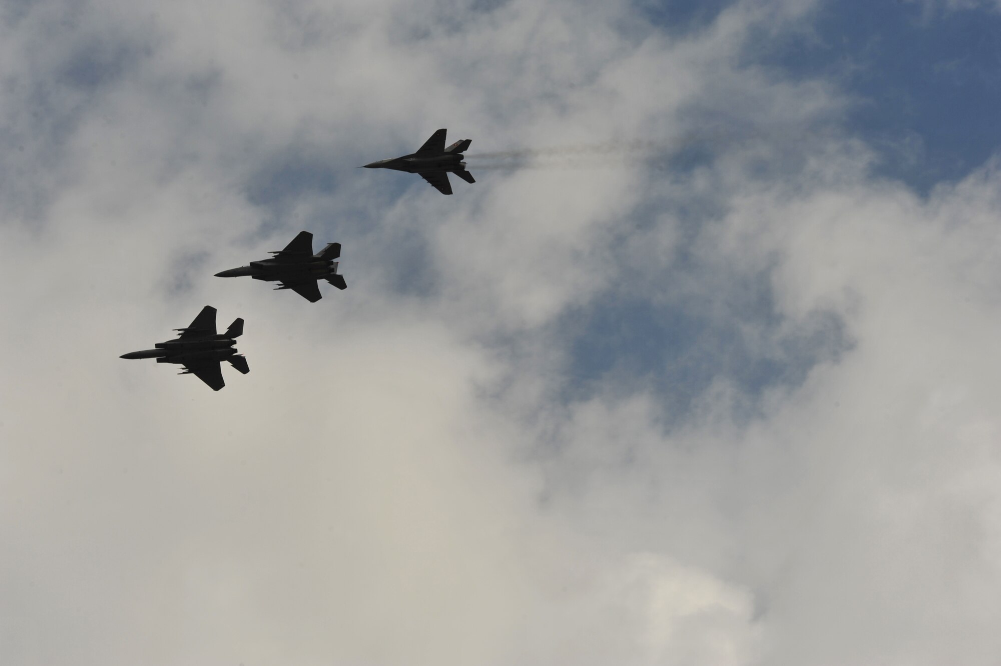 Two F-15C Eagles and a Bulgarian aircraft (right) fly in formation over Graf Ignatievo Air Base near Plovdiv, Bulgaria after conducting joint training in the skies Aug. 25, 2014. Pilots, maintainers and a mixture of other professions from RAF Lakenheath, including Airmen from Ramstein Air Base, Germany will enhance interoperability with Bulgaria and maintain joint readiness. (U.S. Air Force photo/Senior Airman Hailey Haux)