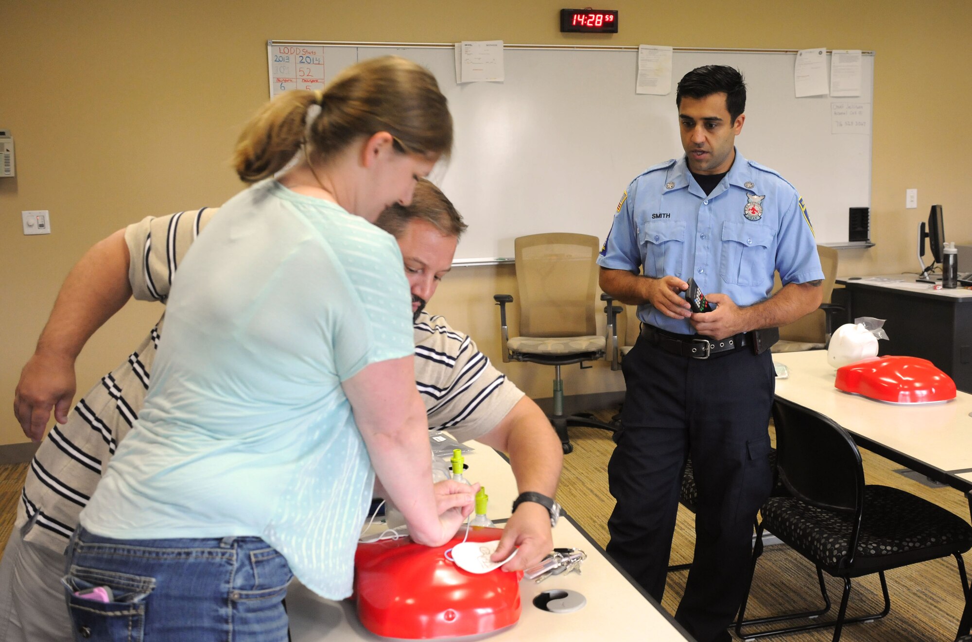 Philip Smith, firefighter, 914 Civil Engineer Squadron, observes students perform automated external defibrillator procedures on August 13, 2014 at the fire station here. Smith is instructing a class on CPR for healthcare providers. (U.S. Air Force photo by Staff Sgt. Matthew Burke)