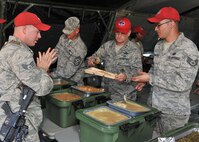 Maj. Gen. H.D. Polumbo, 9th Air Force commander, center, serves dinner to 819th RED HORSE Squadron Airmen Aug. 26 during the squadron’s phase II field training exercise. Polumbo was at Malmstrom Air Force Base, Mont., Aug. 25-27 to visit the 819th RHS and tour the 341st Missile Wing’s nuclear mission. (U.S. Air Force photo/John Turner)
