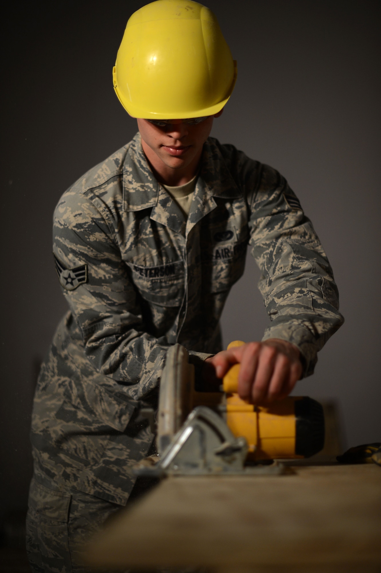 U.S. Air Force Senior Airman Dylan Peterson, a 52nd Civil Engineer Squadron structures technician from Fargo, N.D., saws a sheet of wood at a construction site inside the Skelton Memorial Fitness Center Aug. 26, 2014. The state-of-the-art combat fitness gym may house more than 150 people and support more than 20 classes a week upon its completion. (U.S. Air Force photo by Senior Airman Gustavo Castillo/Released) 