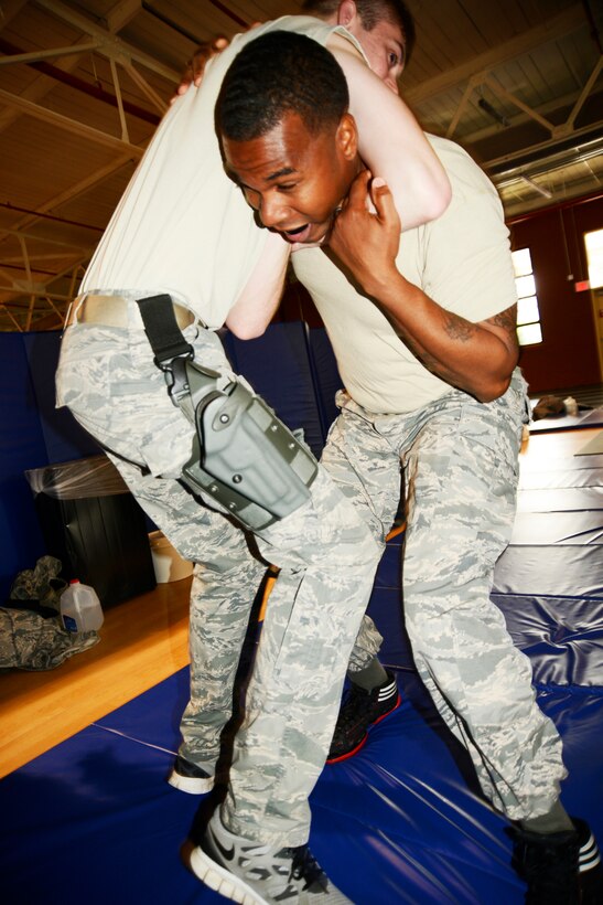 Seventy Eighth Security Forces Squadron Airmen conducted Shoot, Move and Communicate, and Combatives training at the EOD Range and fitness center annex respectively Aug. 19 and 21, 2014. During the SMC training, Airmen hone their skills on how to react. Participants go over different firing positions, fighting stances, maneuvers and communications while targeting the enemy.

Combatives training includes self defense, weapons retention, hand-to-hand combat, submission holds and non-lethal techniques and strikes. The two-part training starts in the morning with intense warm-ups and stretching, followed by basic fighting techniques, including a light sparring session with a partner to recap all of the techniques taught as it applies in use-of-force regulations. (U.S. Air Force photo by Ed Aspera)

