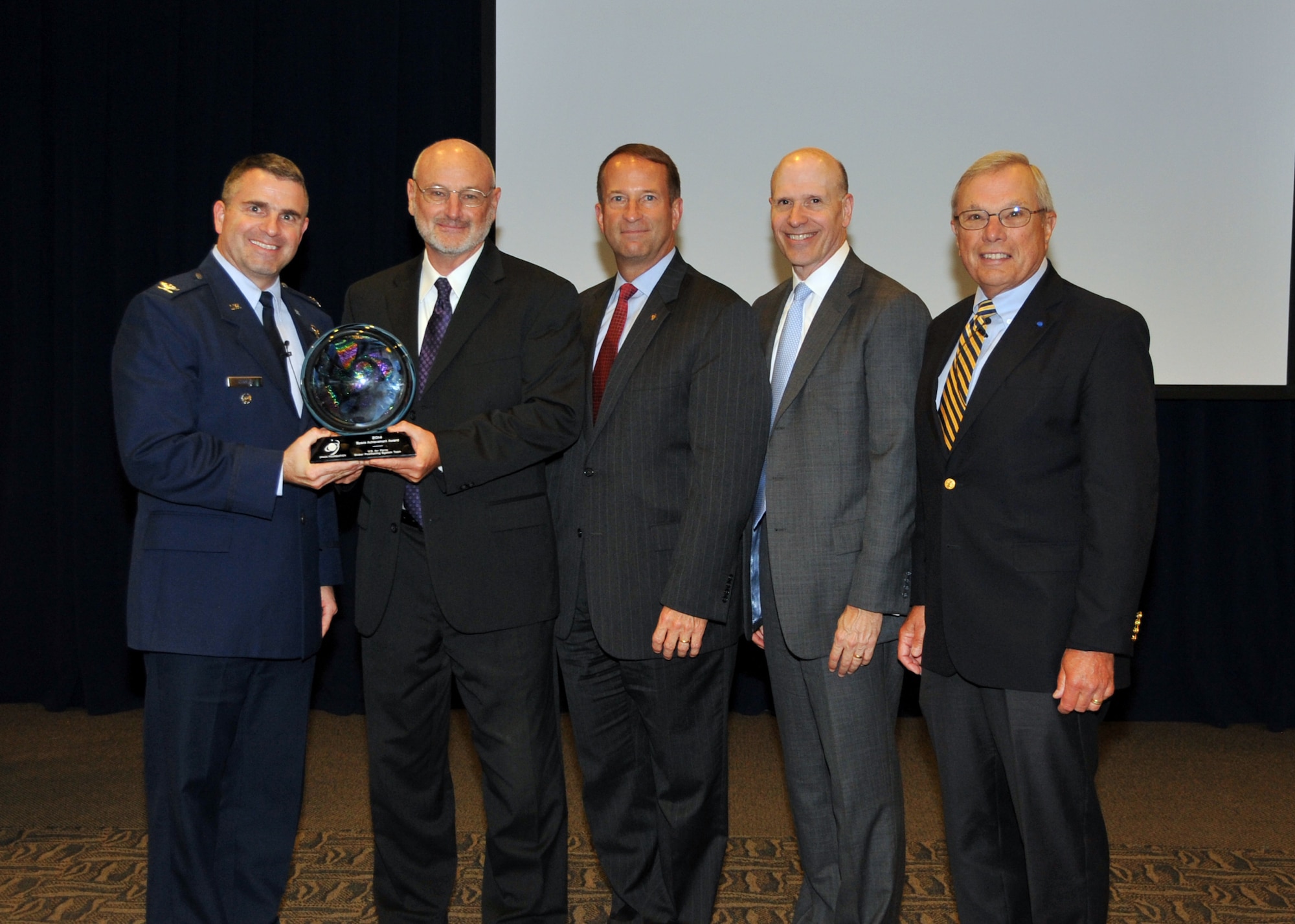 U. S. Air Force Col. William T. Cooley, Director, GPS Directorate hosts the Space and Missile Systems Center 60th Anniversary GPS Heritage Ceremony at Los Angeles Air Force Base in El Segundo, Calif., on August 27, 2014.  The ceremony honors the legacy of GPS systems and recognizing individuals and organizations for space  achievements that represented critical milestones in space development. During the ceremony, the GPS Directorate was presented the 2014 Space Foundation's Space Achievement Award and recognized the 2014 Navstar GPS Hall of Fame recipient, Maj. Gen. (Ret) Robert A. Rosenberg, for his outstanding and distinguished contributions to GPS. Attendees were also treated to a keynote speaker, Dr. Bradford Parkinson. (U.S. Air Force photo by Sarah Corrice)