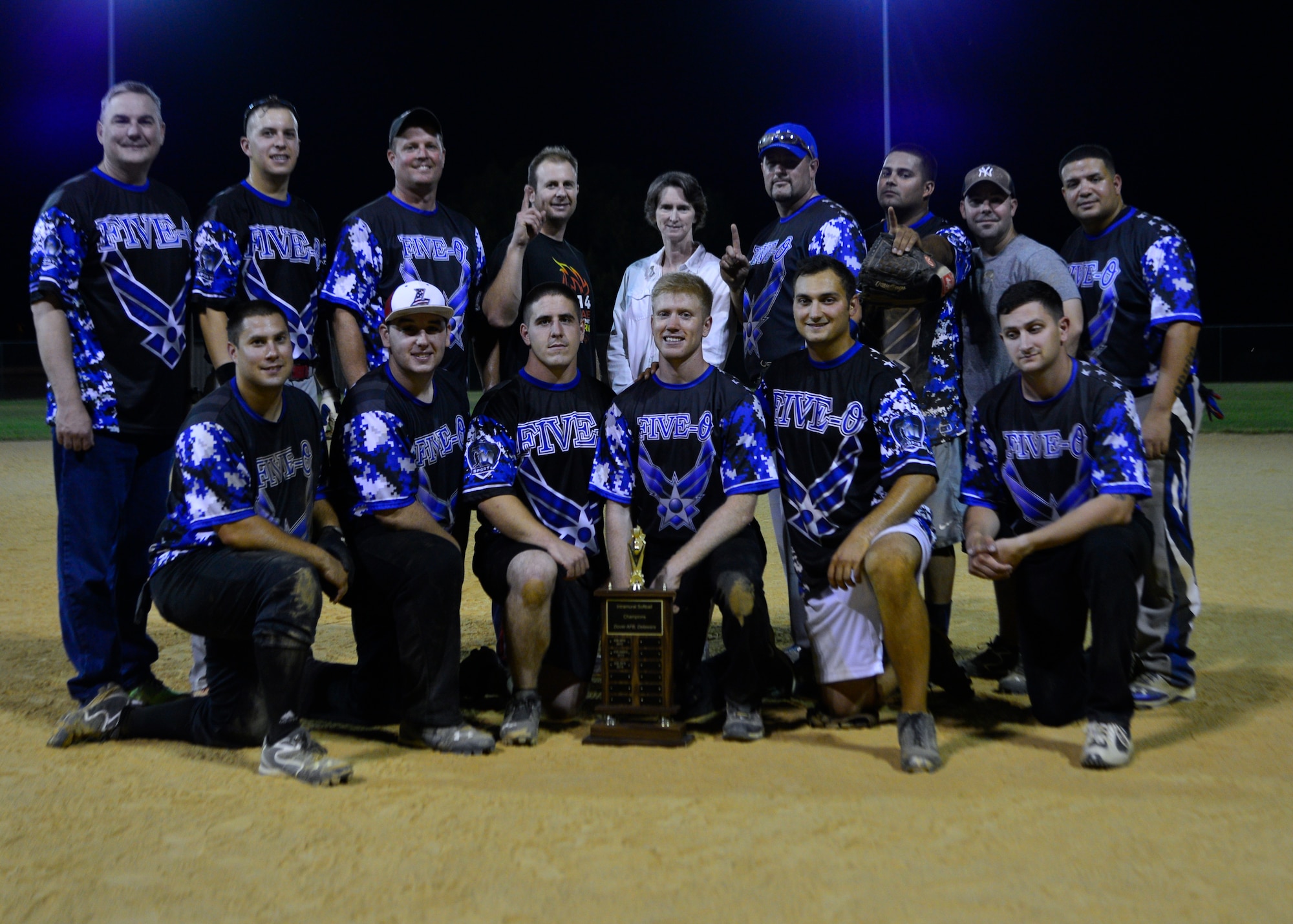 Members of the 436th Security Forces Squadron intramural softball team pose for a team photo after winning the intramural softball championship Aug. 25, 2014, at the softball field on Dover Air Force Base, Del. The 436th SFS beat the 373d Training Squadron 10-9 and 14-8 to win the championship trophy. (U.S. Air Force photo/Airman 1st Class William Johnson)
