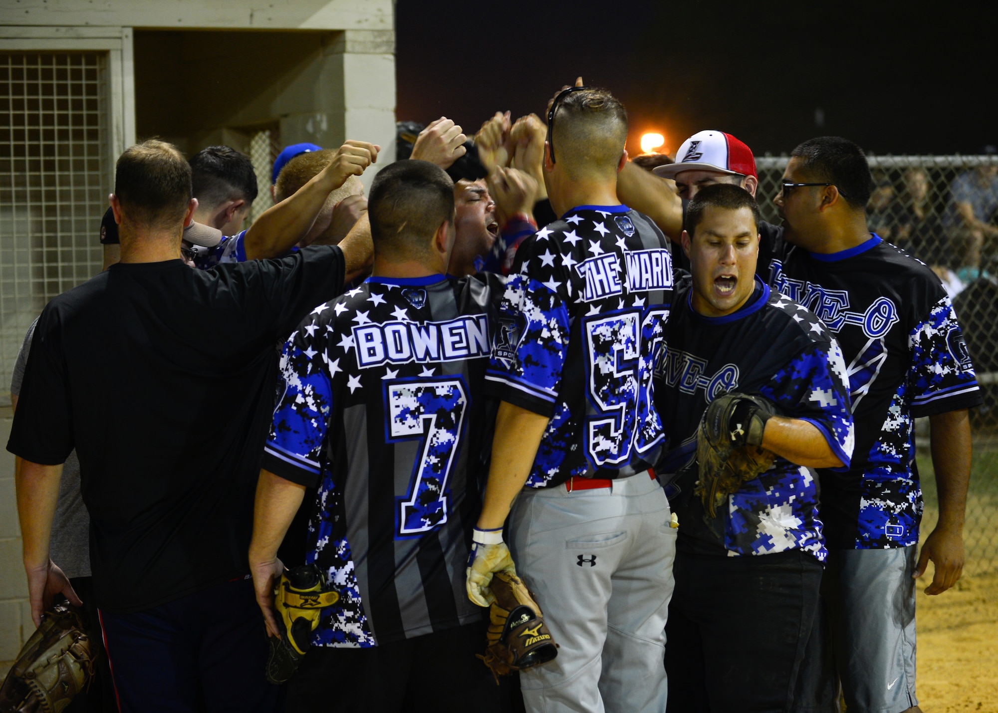 The 436th Security Forces Squadron intramural softball team gathers for a morale speech after winning the first of two games during the intramural softball championship Aug. 25, 2014, at the softball field on Dover Air Force Base, Del. The 436th SFS rose from from the losing bracket and had to win two games against the 373d Training Squadron be win the championship. (U.S. Air Force photo/Airman 1st Class William Johnson)