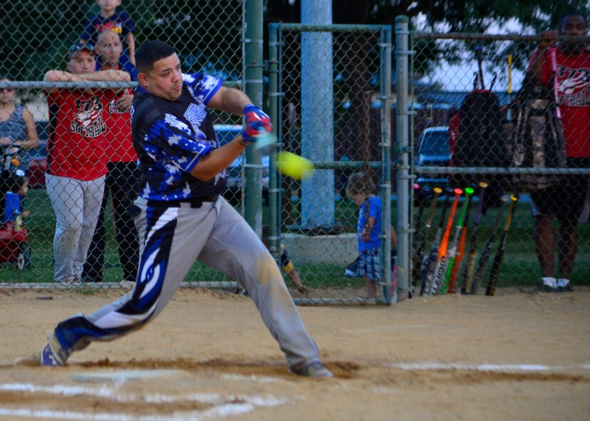 Rafael Gonzalez, 436th Security Forces Squadron player-coach, hits a softball during the intramural softball championship game against the 373d Training Squadron Aug. 25, 2014, at the softball field on Dover Air Force Base, Del. The 436th SFS defeated the 373d TRS 10-9 and 14-8 to win the 2014 intramural softball championship. (U.S. Air Force photo/Airman 1st Class William Johnson) 