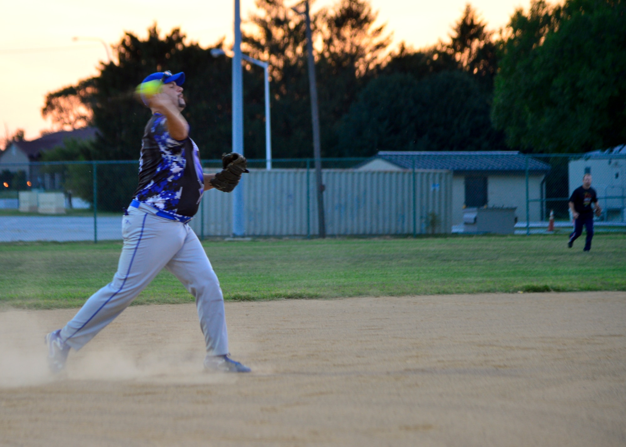 Rick Barker, 436th Security Forces Squadron third baseman, throws to first base during the intramural softball championship game against the 373d Training Squadron Aug. 25, 2014, at the softball field on Dover Air Force Base, Del.  Barker hit a grand slam in the first game which helped the 436th SFS defeat the 373d TRS 10-9 in game one of the championship. (U.S. Air Force photo/Airman 1st Class William Johnson) 