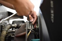 Technical Sgt. Florin Gargarita, an aerospace propulsion craftsman with the 910th Maintenance Squadron, fastens a bolt securing an electrical connection on a C-130H Hercules aircraft engine during an isochronal inspection here, Aug.25. Each Youngstown C-130 undergoes an isochronal inspection every 540 days. 910th Maintainers now perform the inspections using a new, $1.5 million dock stand system designed to increase efficiency and safety for workers. YARS is the first installation in Air Force Reserve Command to acquire the system beyond its prototype phase. U.S. Air Force photo/Eric M. White.