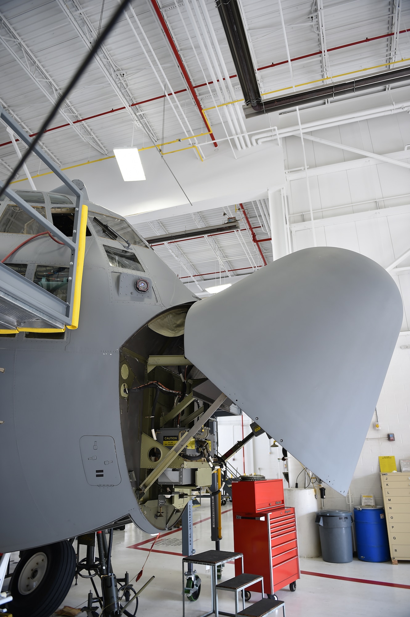 The nose of a C-130H Hercules aircraft is propped open for maintenance access during an isochronal inspection here, Aug.25. Each Youngstown C-130 undergoes an isochronal inspection every 540 days. 910th Maintainers now perform the inspections using a new, $1.5 million dock stand system designed to increase efficiency and safety for workers. YARS is the first installation in Air Force Reserve Command to acquire the system beyond its prototype phase. U.S. Air Force photo/Eric M. White.