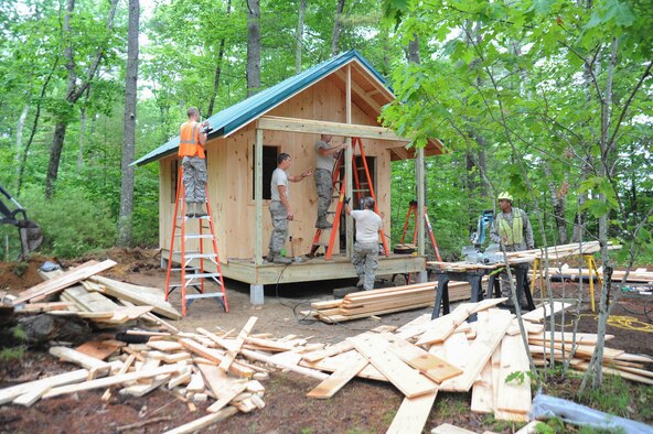 Airmen from the Kentucky Air National Guard’s 123rd Civil Engineer Squadron build a cabin for scouts and scout masters at Camp William Hinds Boy Scout camp in Raymond, Maine on June 13, 2014. About 30 members from the 123rd Airlift Wing went to Maine for its annual deployment for training from June 1-15 to help renovate camp facilities for the Boy Scouts of America. (Courtesy Photo) 