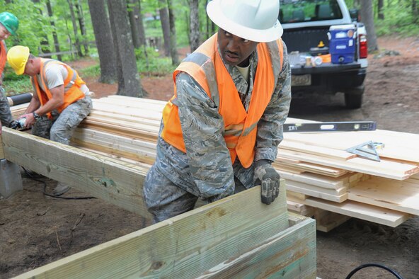 Lt. Col. Rodney Boyd, vice-commander of the 123rd Civil Engineer Squadron, prepares lumbers for a new cabin for scouts and scout masters at Camp William Hinds Boy Scout camp in Raymond, Maine on June 5, 2014. About 30 members from the 123rd Airlift Wing went to Maine for its annual deployment for training from June 1-15 to help renovate camp facilities for the Boy Scouts of America. (Courtesy Photo) 