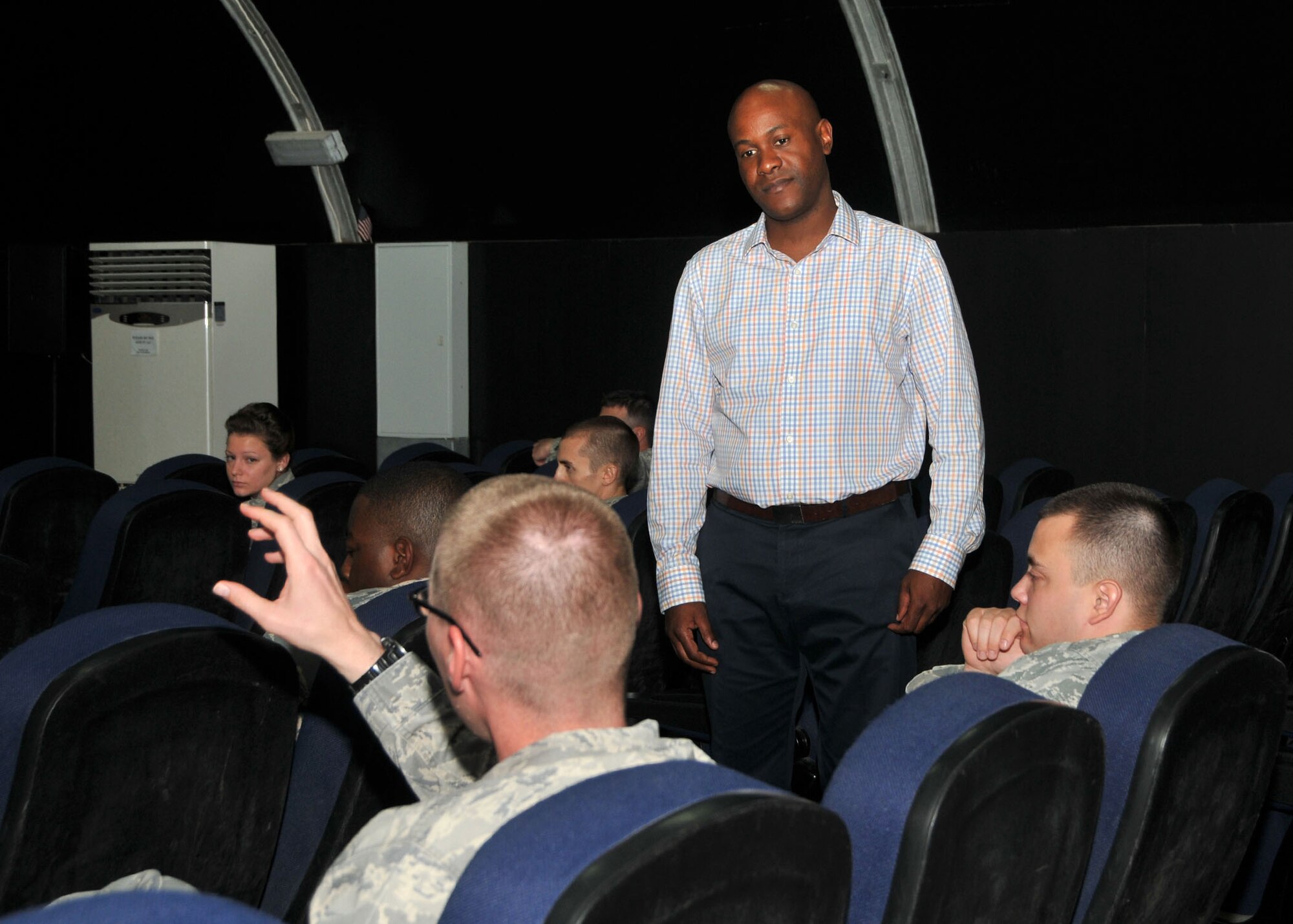 Combined Federal Campaign-Overseas Campaign Manager Chidley Lafontant answers questions from 380th Air Expeditionary Wing members on issues related to the 2015 CFC campaign in the base theater at an undisclosed location in Southwest Asia, Aug. 26, 2014. (U.S. Air National Guard photo by Senior Master Sgt. Eric Peterson/Released)