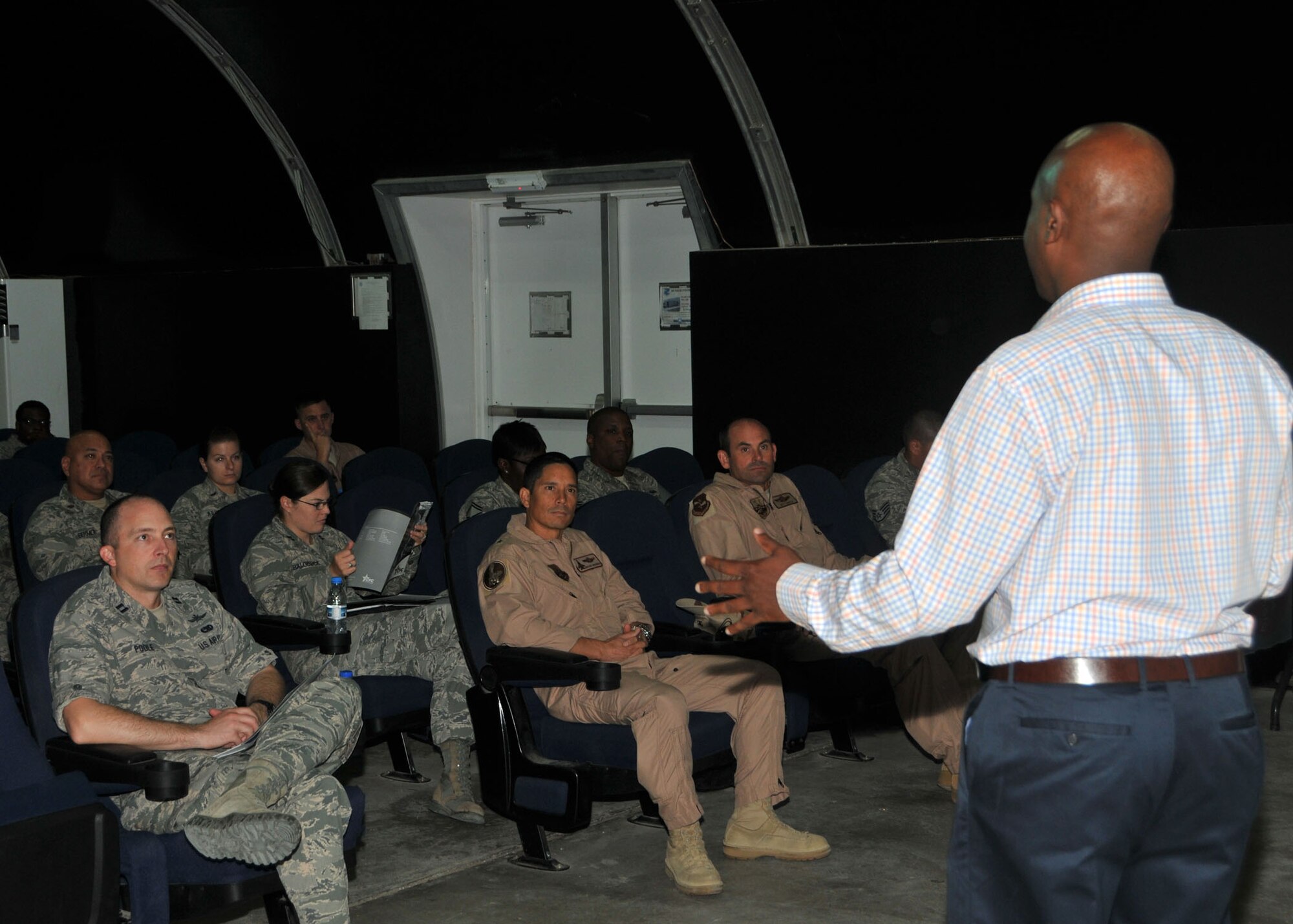 Combined Federal Campaign-Overseas Campaign Manager Chidley Lafontant briefs 380th Air Expeditionary Wing leadership and members on the 2015 CFC campaign in the base theater at an undisclosed location in Southwest Asia, Aug. 26, 2014. (U.S. Air National Guard photo by Senior Master Sgt. Eric Peterson/Released)

