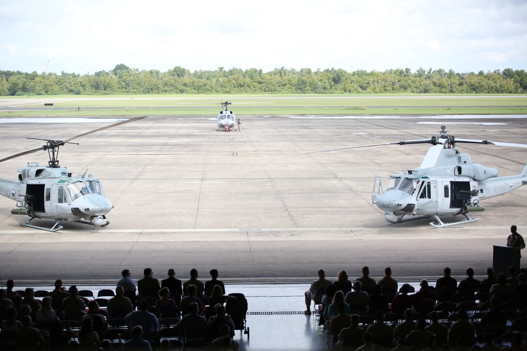 Marines, sailors and members of the community attend the final flight ceremony of the UH-1N Huey helicopter for Marine Light Attack Helicopter Squadron 773, Marine Aircraft Group 49, aboard Naval Air Station Joint Reserve Base, New Orleans, Aug. 28, 2014. The UH-1N Huey (Left) is a twin engine, utility helicopter that first flew in April 1969. The UH-1Y Venom (Right) provides drastically improved capabilities to its predecessor in terms of range, airspeed, payload, survivability and lethality.