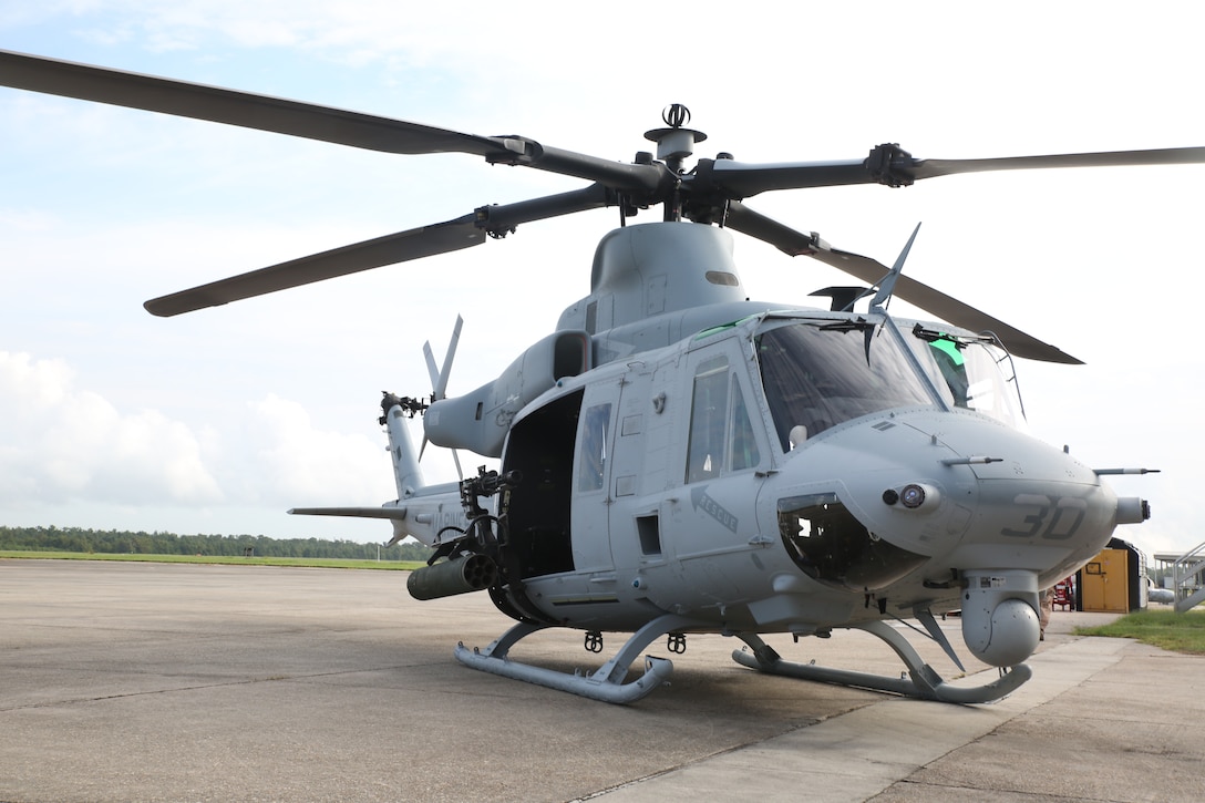 A UH-1Y Venom helicopter with Marine Light Attack Helicopter Squadron 773, Marine Aircraft Group 49, is displayed for ceremony attendees to view during a final flight ceremony for the UH-1N Huey helicopter aboard Naval Air Station Joint Reserve Base, New Orleans, Aug. 28, 2014. The UH-1Y’s increased power margin makes it a viable platform for a wide range of assault support missions including maritime interdiction and visit, board, search and seizure missions and more.