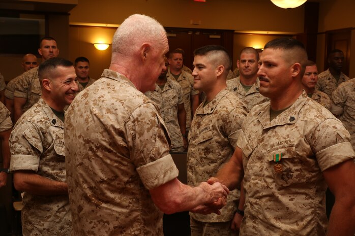 Sergeants Philip Kelly (Near) and Derrek Cardinale (Far), receive Navy and Marine Corps Achievement Medals from Lt. Gen. Richard P. Mills, commander of Marine Forces Reserve, for their work as Lance Corporal Leadership Ethics Seminar trainers after educating senior enlisted advisors in the Marine Corps Support Facility New Orleans auditorium, Aug. 27, 2014. The train-the-trainer course was designed to inform senior enlisted advisors on the new Lance Corporal Leadership Ethics Seminar implemented throughout the Marine Corps. The seminar was implemented to inform lance corporals of the resources available to them, as well as motivate them to succeed and strive for the next rank.  