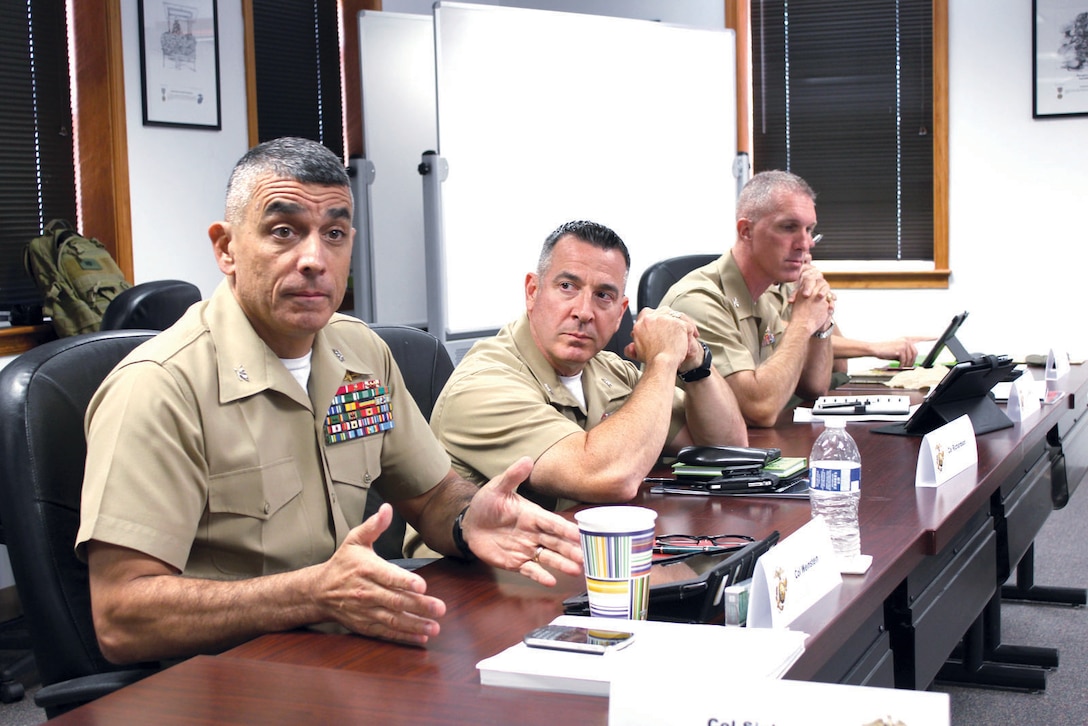 Col. Clifford Weinstein, commanding officer, 10th Marine Regiment, 2nd Marine Division, Marine Corps Base Camp Lejeune, N.C., left, and Col. Darren Richardson, deputy commander of the 4th Marine Logistics Group, Marine Forces Reserve in New Orleans, and Col. Gerard Wynn, assistant chief of staff for operations and plans at the Marine Corps Forces Command Individual Mobilization Augmentee, engage in a discussion during the “Senior Planners Course” on Aug. 20 at Marine Corps University aboard Marine Corps Base Quantico.