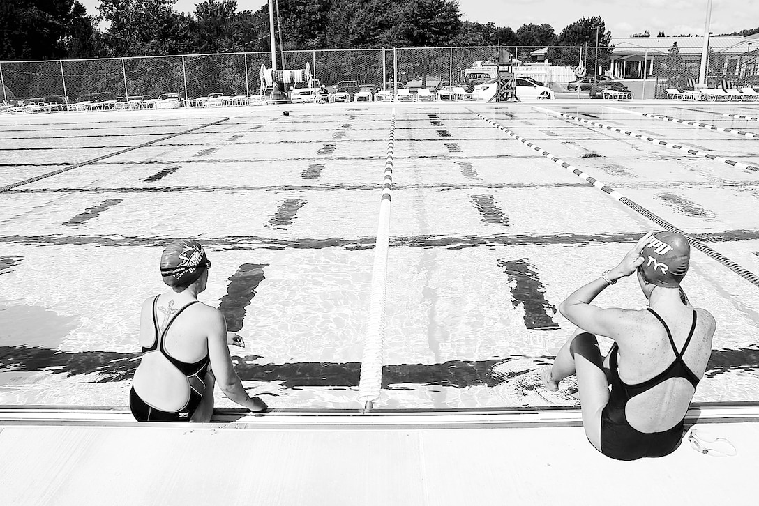 Patrons of Marine Corps Base Quantico’s 50M Pool sit on the pool’s edge before swimming laps Aug. 25.