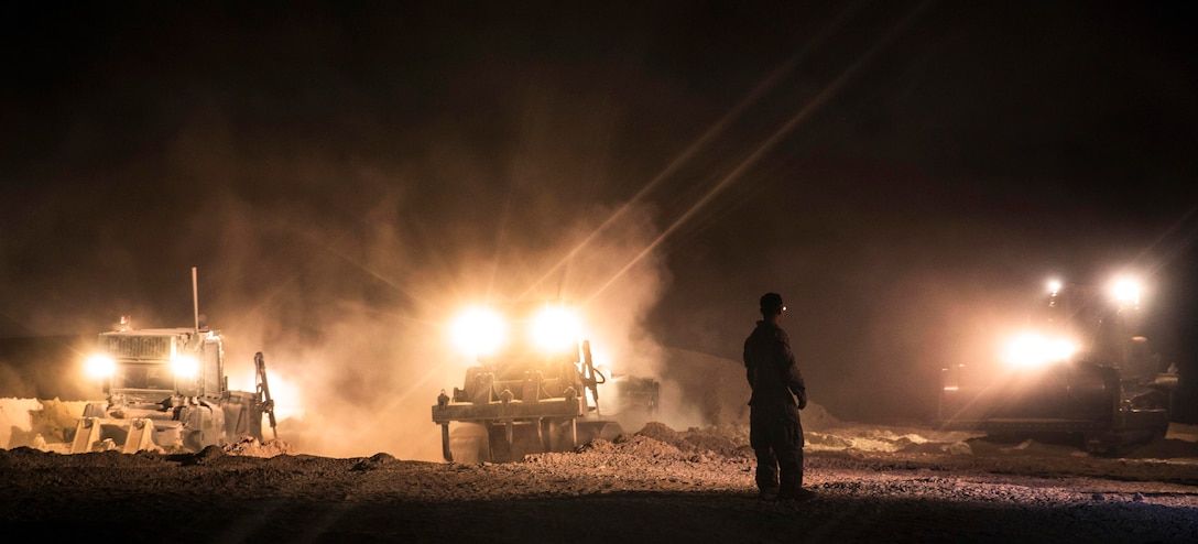 U.S. Marine Cpl. James Vaughn, foreground, observes as Marines use ...