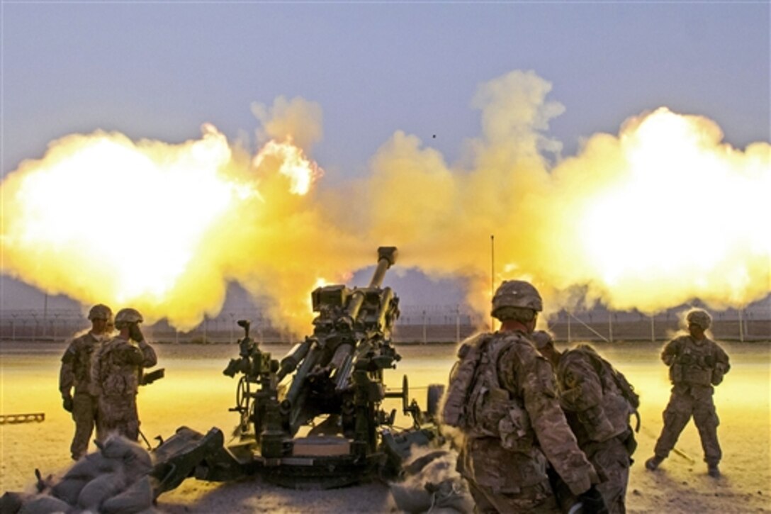 U.S. soldiers fire a round down range from their M777A2 howitzer on Kandahar Airfield, Afghanistan, Aug. 22, 2014. The soldiers are assigned to the 4th Infantry Division's 2nd Battalion, 77th Field Artillery Regiment, 4th Infantry Brigade Combat Team. The round was part of a shoot to register, or zero, the howitzers, which had just arrived on the airfield from Forward Operating Base Pasab.
