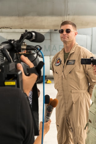 Maj. William Smith, operations officer with Marine Aerial Refueler Transport Squadron 152, answers questions from Iwakuni City Base Policy representatives, media and Government of Japan’s Ministry of Defense representatives immediately after a familiarization flight of a KC-130J Super Hercules, Aug. 28, 2014, aboard Marine Corps Air Station Iwakuni, Japan. The visitors asked questions involving the aircraft’s mission, capabilities and functions, and also flew aboard the C-130 to gain a better understanding of its capabilities. 