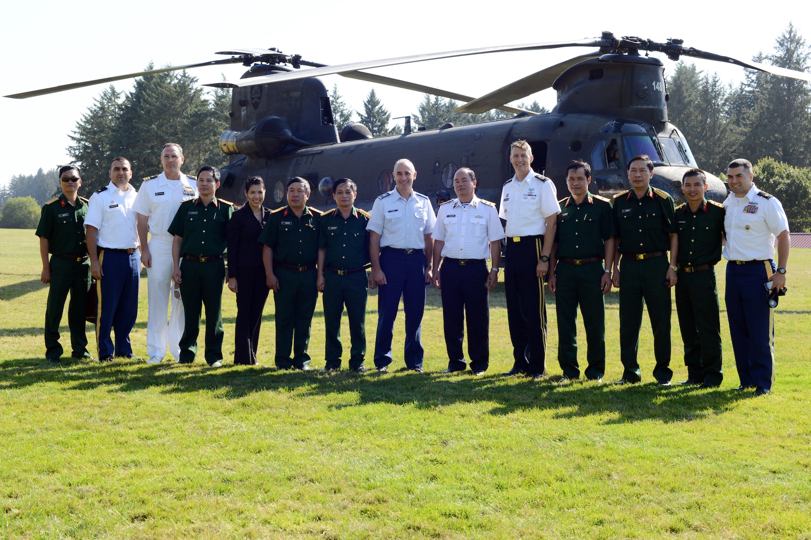 Vice Admiral Pham Ngoc Minh (center), Deputy Chief of General Staff of Vietnam People’s Army and Vice Standing Chairman of Vietnam’s National Committee for Search and Rescue (VINASARCOM), and other visitors with the VINASARCOM delegation pose for a group photo with their hosts, Maj. Gen. Daniel Hokanson (on Minh’s left), Adjutant General, Oregon, and other members of the Oregon National Guard after visiting the Oregon National Guard’s CBRNE Enhanced Response Force Package (CERFP) annual certification training exercise, Aug. 25, at Camp Rilea in Warrenton, Ore. 