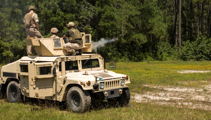 Marines with II Marine Expeditionary Force fire the Non-Lethal, Tube-Launched Munitions System from a vehicle at Camp Lejeune, North Carolina, Aug. 14, 2014. The live fire showcased the versatility and shock and awe effect of the NLTLMS and how effective it can be at a vehicle checkpoint. Marine Corps Systems Command Optics and Non-Lethal Systems is fielding the system that sends non-lethal munitions out as far as 500 meters and uses an audible bang to deter a crowd or a person with mal-intent. 