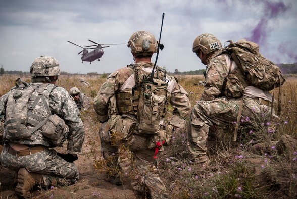 Tech. Sgt. Matthew Spittler, right, and Senior Airman Tyler Trocano, center, await extraction with Sgt. 1st Class Steven Sparks from 2nd platoon, Charlie Troop, Team 2-2, 1st Battalion, 126th Cavalry Regiment, Michigan National Guard, Dowagiac, Mich. on a CH-47 Chinook helicopter from the Illinois Army National Guard. The training took place during Operation Northern Strike 2014 near Grayling, Mich. on Aug. 11, 2014. Both Airmen are Joint Terminal Air Controllers from the 148th Air Support Operations Squadron, Fort Indiantown Gap, Pa. Operation Northern Strike 2014 is a joint multinational combined arms training exercise conducted in Michigan. (U.S. Air National Guard photo/Master Sgt. Scott Thompson)