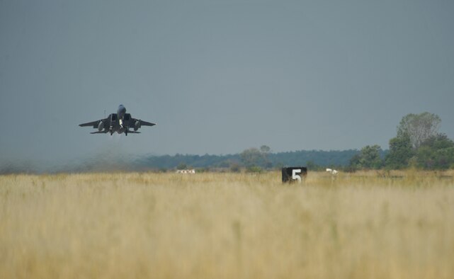 An F-15C Eagle takes off on a training mission with a Bulgarian aircraft at Graf Ignatievo Air Base near Plovdiv, Bulgaria, Aug. 21, 2014. Pilots, maintainers and a mixture of other professions from RAF Lakenheath, England, including Airmen from Ramstein Air Base, Germany will enhance interoperability with Bulgaria and maintain joint readiness. (U.S. Air Force photo/Senior Airman Hailey Haux)