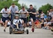 Members of the 319th Logistics Readiness Squadron push and drive toward the finish line during the Summer Bash bed race Aug. 21, 2014, on Grand Forks Air Force Base, N.D. Each team consisted of four pushers or pullers and one driver. The driver had to perform several tasks from one end of the lane in order to cross the finish line. (U.S. Air Force photo/Senior Airman Xavier Navarro)