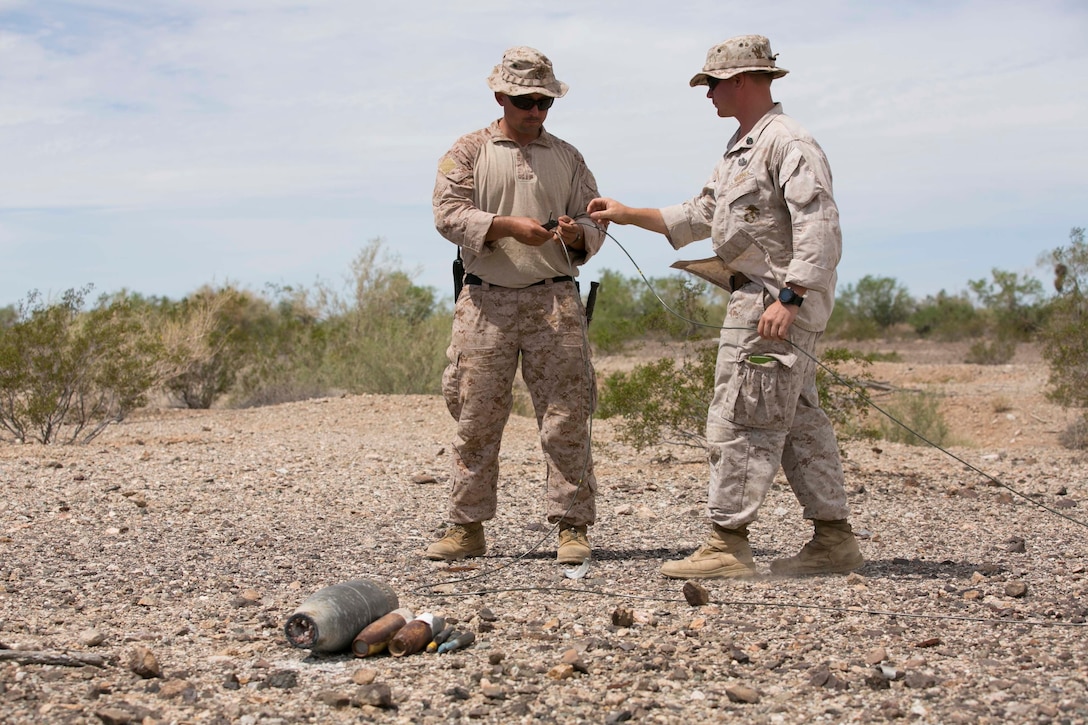 Gunnery Sgt. Phillip Walkoviak, left, an Explosive Ordnance Disposal technician with Marine Wing Support Squadron 372 from Marine Corps Base Camp Pendleton, Calif., and Staff Sgt. Robbie Grieder, the range officer-in-charge and an EOD technician team leader with Headquarters & Headquarters Squadron at Marine Corps Air Station Yuma, Ariz., and a native of Belleplaine, Iowa, prepare unexploded ordnance to be detonated during range clearance operations at the Chocolate Mountain Aerial Gunnery Range, Calif., Monday, Aug. 25, 2014.