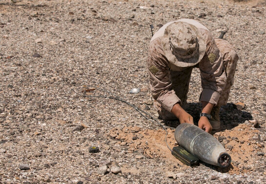Gunnery Sgt. Phillip Walkoviak, an Explosive Ordnance Disposal technician with Marine Wing Support Squadron 372 from Marine Corps Base Camp Pendleton, Calif., prepares unexploded ordnance to be detonated during range clearance operations at the Chocolate Mountain Aerial Gunnery Range, Calif., Monday, Aug. 25, 2014.