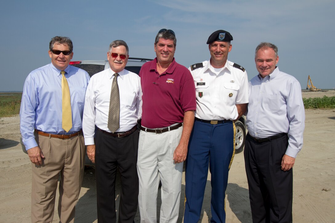 Bill Cofer (left), president of the Virginia Pilot Association, Jeff Florin, Virginia Port Authority deputy executive director, John Bull, commissioner of the Virginia Marine Resources Commission, Col. Paul Olsen, Norfolk District commander, and Senator Tim Kaine, pose for a group shot at the Norfolk District's Craney Island Dredged Material Management Area. The senator recieved a briefing about the status of the facility's expansion and its importance to the local, regional and national economy. (U.S. Army photo/Patrick Bloodgood)