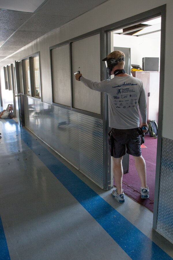 Cpl. Brian Bowman, simulated active shooter during an active shooter exercise called “Operation Social Fury,” and a Charlotte, N.C., native, fires simulated bullets down a hallway to make noise at the Recycling Center aboard Marine Corps Air Station Miramar, Calif., Aug. 27. Bowman and a partner notionally took over the center to cause harm to their peers. A short while later, military police entered the building in search of their suspects.