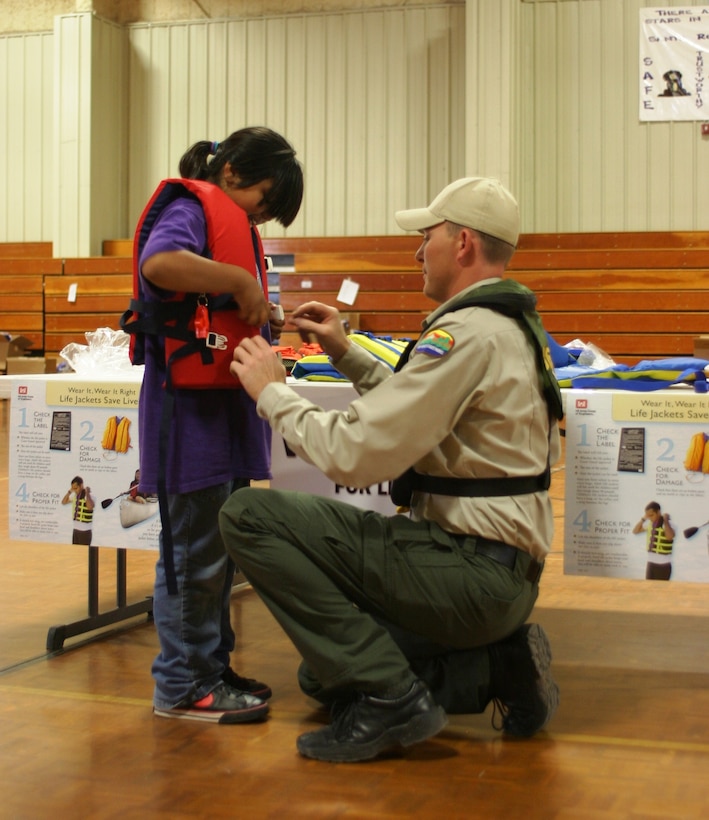 SANTA ROSA, N.M., -- A New Mexico State Parks ranger checks the fit of a life jacket on a Santa Rosa Elementary student. It's important to not only wear a life jacket, but to wear a properly fitting life jacket! 