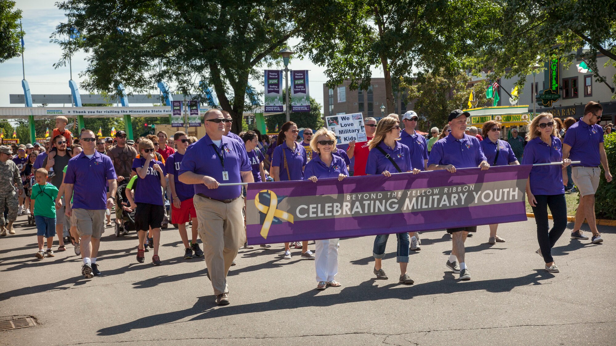 Children of military members and veterans walk in the parade at the Minnesota State Fair August 26. Members of the 934th Airlift Wing were at the fair showcasing the wing for Military Appreciation Day. (U.S. Air Force photo/Paul Zadach)