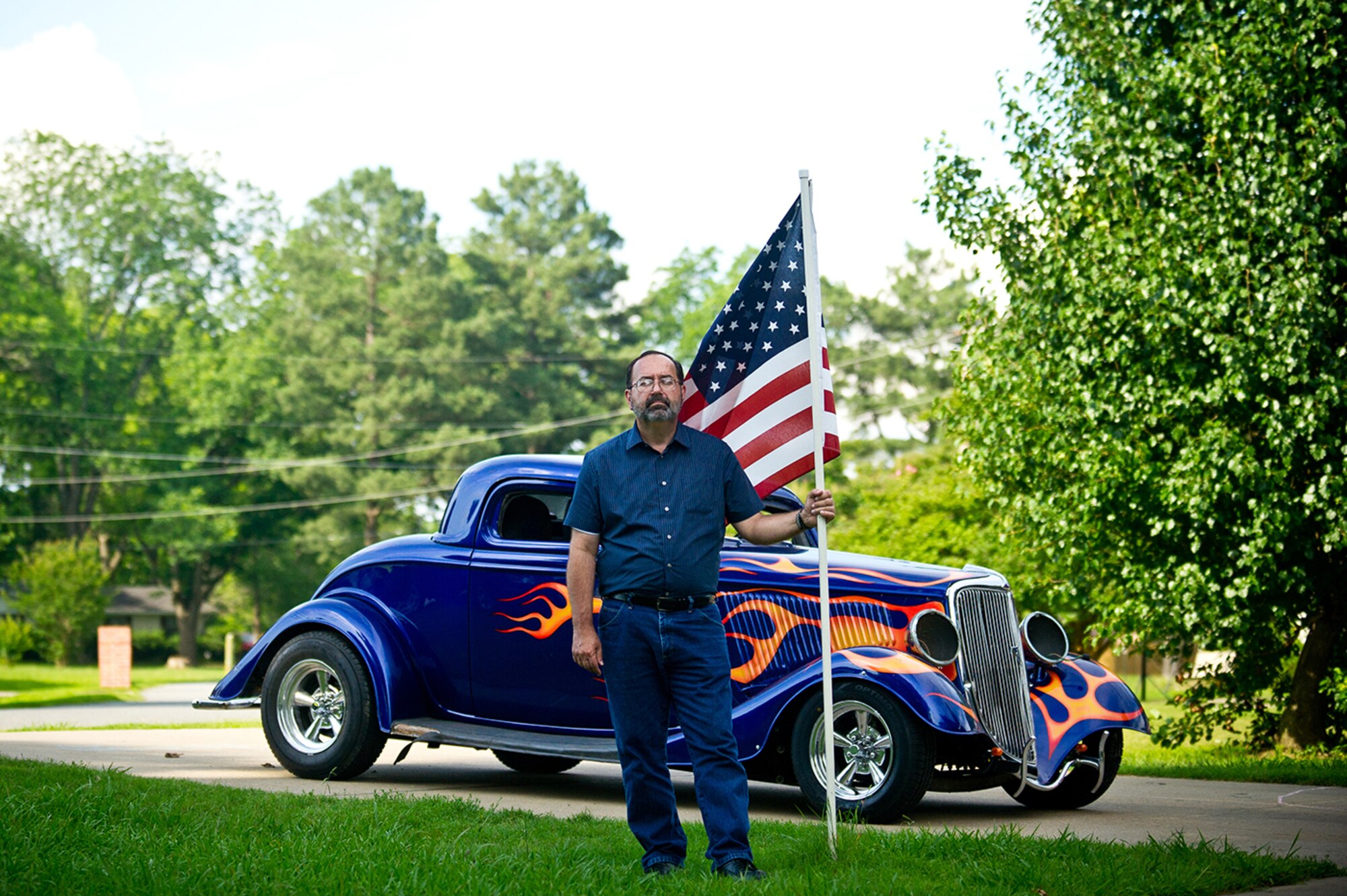 Daniel Wassom, father of Master Sgt. Daniel R. Wassom II, tells stories of spending time rebuilding the 1934 Ford Coupe with his son. (U.S. Air Force photo by Tech. Sgt. Sarayuth Pinthong/ Released)