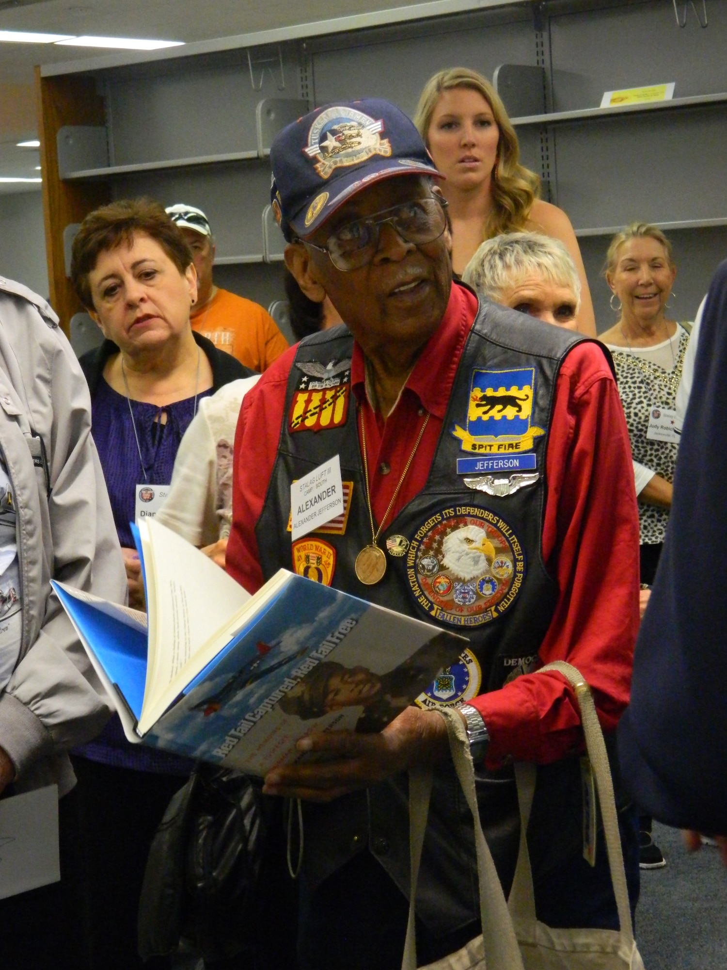 Retired Lt. Col. Alexander Jefferson, 93, visited the Academy Aug. 28 to attend a World War II Prisoners of War reunion. Jefferson, a Tuskegee Airman, was held at Stalag Luft III, a German POW camp in Sagan (now Zagan), Poland. He's holding the book he wrote about his experiences, "Red Tail Captured, Red Tail Free: Memoirs of a Tuskegee Airman and POW." 