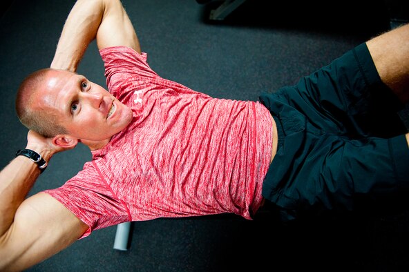 U.S. Air Force Lt. Col. Stephen Frank, instructor pilot, 559 Flying Training Squadron, does slow control decline sit-ups, 16 July, 2014, Joint Base San Antonio-Randolph, Texas. (U.S. Air Force photo by Tech. Sgt. Sarayuth Pinthong/ Released)